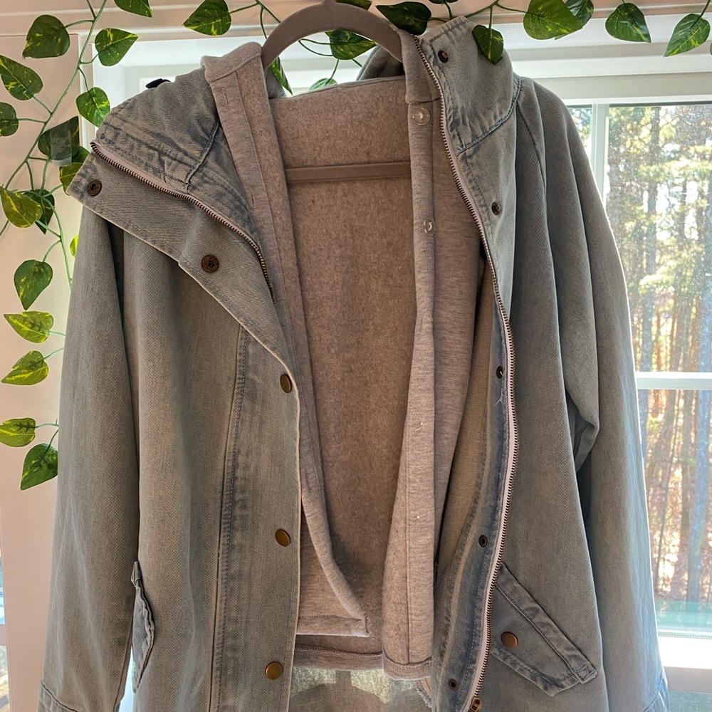 Jean jacket with sleeveless hoodie underneath.